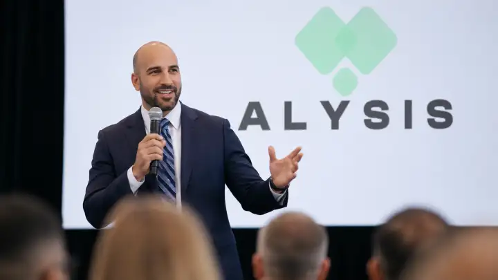 Calum Wayne speaking at an Alysis event